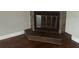Cozy corner fireplace with stone surround and dark wood flooring at 8033 55Th E St, Palmetto, FL 34221