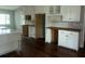 Spacious kitchen with white cabinetry, dark floors, and work desk at 8033 55Th E St, Palmetto, FL 34221