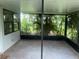Screened-in patio with brick flooring and views of lush backyard landscaping at 8033 55Th E St, Palmetto, FL 34221