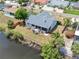 Aerial view of waterfront home with fenced yard, screen porch, and private dock at 832 Birdie Way, Apollo Beach, FL 33572