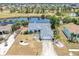 Aerial view of a well-maintained home with a backyard pond and proximity to a community park at 832 Birdie Way, Apollo Beach, FL 33572
