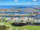 Aerial view of homes in a waterfront community, near a golf course at 832 Birdie Way, Apollo Beach, FL 33572