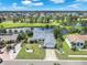 Aerial view showcasing the home, its landscaping, and a nearby pond within the surrounding community at 832 Birdie Way, Apollo Beach, FL 33572