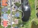 Overhead view of a home with landscaped yard, long driveway, and waterfront views at 832 Birdie Way, Apollo Beach, FL 33572