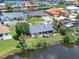 Aerial view of a home's screened lanai, set along a waterfront with lush green backyard at 832 Birdie Way, Apollo Beach, FL 33572