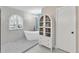 Bright bathroom features an arched window, standalone tub, and built-in storage at 832 Birdie Way, Apollo Beach, FL 33572