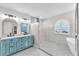 Bright bathroom featuring a double vanity, walk-in shower, hexagon tile floor, and freestanding tub at 832 Birdie Way, Apollo Beach, FL 33572