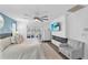 Sun-filled bedroom featuring a modern fireplace, tv, and sliding door access to a private balcony at 832 Birdie Way, Apollo Beach, FL 33572