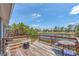Waterfront deck with seating provides a scenic view of the surrounding nature at 832 Birdie Way, Apollo Beach, FL 33572