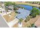 Aerial view of home with lush landscaping, a driveway, and a view of the lake in the back at 832 Birdie Way, Apollo Beach, FL 33572