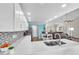 Open-concept kitchen featuring quartz countertops and seamless flow into the living area at 832 Birdie Way, Apollo Beach, FL 33572