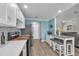 Updated kitchen with white cabinets, stainless appliances, and a convenient coffee bar area at 832 Birdie Way, Apollo Beach, FL 33572