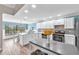 Bright kitchen featuring white cabinets, stainless steel appliances, and a breakfast nook at 832 Birdie Way, Apollo Beach, FL 33572