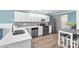 Bright kitchen with white cabinets, stainless steel appliances, and a stylish backsplash at 832 Birdie Way, Apollo Beach, FL 33572