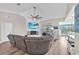 Open living room featuring a brick fireplace, large sectional sofa, and patio access at 832 Birdie Way, Apollo Beach, FL 33572
