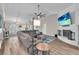 Inviting living room with a brick fireplace, large TV, and comfortable seating arrangement at 832 Birdie Way, Apollo Beach, FL 33572