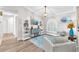 Cozy living room with hardwood floors, decorative shelving, and comfortable seating at 832 Birdie Way, Apollo Beach, FL 33572