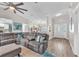 Spacious living room featuring hardwood floors, comfortable seating, and natural light at 832 Birdie Way, Apollo Beach, FL 33572