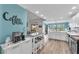 Open-concept living space features a modern kitchen, dining area, and a spacious living room at 832 Birdie Way, Apollo Beach, FL 33572