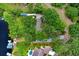 Aerial view of a property with mature trees and lush landscaping, showcasing its serene and private setting at 8903 Donna Lu Dr, Odessa, FL 33556