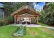 Charming backyard with a tiki hut covered patio, perfect for enjoying outdoor living and entertaining in style at 8903 Donna Lu Dr, Odessa, FL 33556