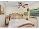 Comfortable bedroom with wood-look floors, ceiling fan, and cozy bedding provides a serene retreat with natural lighting at 8903 Donna Lu Dr, Odessa, FL 33556