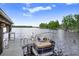 Boat dock featuring a boat, seating and fishing pole holders on a sunny day on the lake at 8903 Donna Lu Dr, Odessa, FL 33556