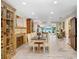 Bright dining room featuring decorative fireplace, vintage cabinetry, and views of the lush backyard and lake at 8903 Donna Lu Dr, Odessa, FL 33556