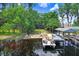 Lush greenery surrounds a waterfront property with a private boat dock, offering a serene and picturesque setting at 8903 Donna Lu Dr, Odessa, FL 33556