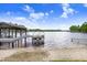 Picturesque waterfront view with a private boat dock, offering direct access to the tranquil lake for boating and recreation at 8903 Donna Lu Dr, Odessa, FL 33556