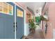 Stylish front door with a brick pathway, lantern lighting, and decorative accents at 8903 Donna Lu Dr, Odessa, FL 33556