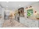 Bright kitchen featuring white cabinets, granite counters, stainless steel appliances, and decorative lighting at 8903 Donna Lu Dr, Odessa, FL 33556