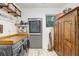 Well-equipped laundry room features modern washer/dryer, built in shelves, and wood countertop for folding at 8903 Donna Lu Dr, Odessa, FL 33556
