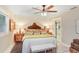 Cozy bedroom featuring a decorative headboard, plush bedding, wood-look floors and abundant natural light at 8903 Donna Lu Dr, Odessa, FL 33556