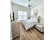 Bright bedroom with a ceiling fan, window, bed, dresser and chair at 9024 Barrier Coast Trl, Parrish, FL 34219