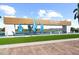 Del Webb Bayview community entrance featuring modern architecture, landscaping, and water features creating curb appeal at 9024 Barrier Coast Trl, Parrish, FL 34219