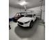 Well-organized garage with a car and golf cart, offering ample parking and storage at 9024 Barrier Coast Trl, Parrish, FL 34219