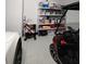 A well-equipped garage includes a golf cart and storage shelves at 9024 Barrier Coast Trl, Parrish, FL 34219