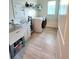 Functional laundry room with a washer, dryer, sink, and storage shelves at 9024 Barrier Coast Trl, Parrish, FL 34219