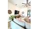 Inviting living room featuring a ceiling fan, stylish decor, and a cozy seating area at 9024 Barrier Coast Trl, Parrish, FL 34219