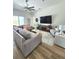 Bright and spacious living room with hardwood floors, large windows, and comfortable seating at 9024 Barrier Coast Trl, Parrish, FL 34219