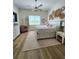 Airy bedroom with hardwood floors, natural light, and decorative wall art at 9024 Barrier Coast Trl, Parrish, FL 34219
