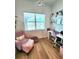 Charming office with a pink chair, desk, and large window with a pool view at 9024 Barrier Coast Trl, Parrish, FL 34219