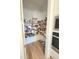 Well-organized walk-in pantry with wire shelving and hardwood flooring at 9024 Barrier Coast Trl, Parrish, FL 34219