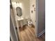 Cozy powder room with pedestal sink and neutral decor, perfect for guests at 9024 Barrier Coast Trl, Parrish, FL 34219