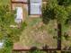 An aerial view of the backyard with storage shed and screened in patio area at 932 W Wheeler Rd, Brandon, FL 33510