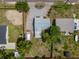 Aerial view of the home with a long driveway, storage shed and fenced in back yard at 932 W Wheeler Rd, Brandon, FL 33510