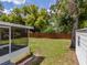 Spacious backyard featuring a screened-in lanai and lush landscaping at 932 W Wheeler Rd, Brandon, FL 33510