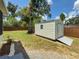 Backyard with a metal storage shed and mature trees at 932 W Wheeler Rd, Brandon, FL 33510