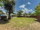 View of the backyard with a shed and screened lanai at 932 W Wheeler Rd, Brandon, FL 33510